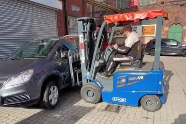 For fork's sake! Irate businessman uses forklift to move car parked in front of his warehouse