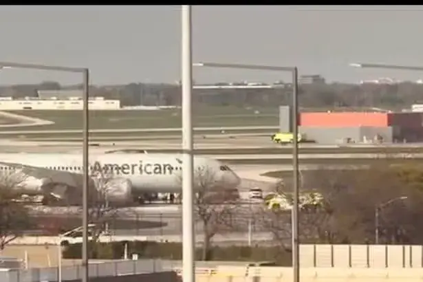 Emergency crews swarm American Airlines plane after it 'blows two tyres' on landing