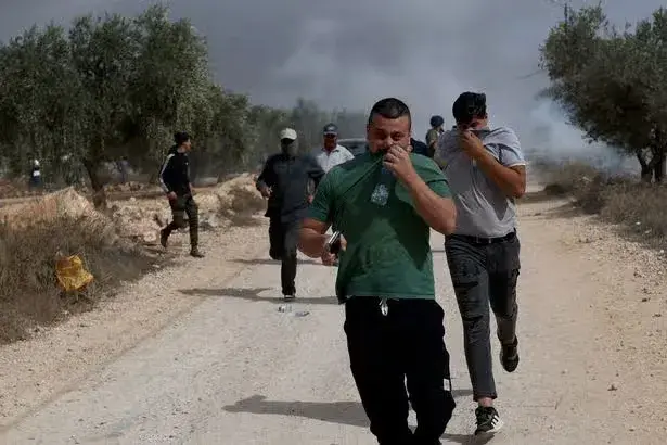 Violence flares in West Bank as settler gangs torch cars and attack farmers during olive harvests